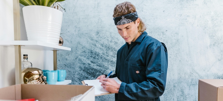 a mover doing inventory before providing packing services San Antonio