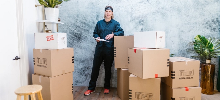 One of the movers Terrell Hills TX standing near cardboard boxes
