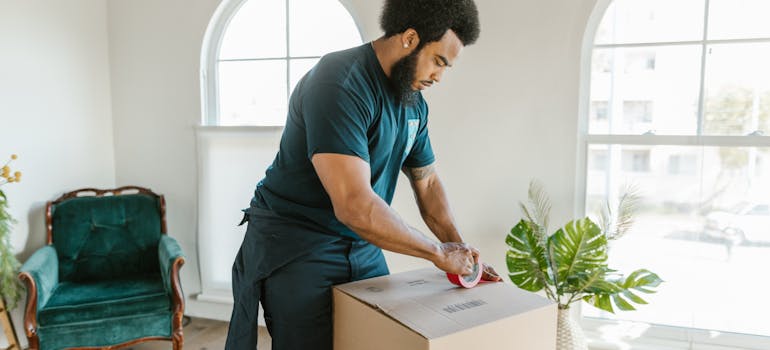 One of the movers Shavano Park TX packing a moving box
