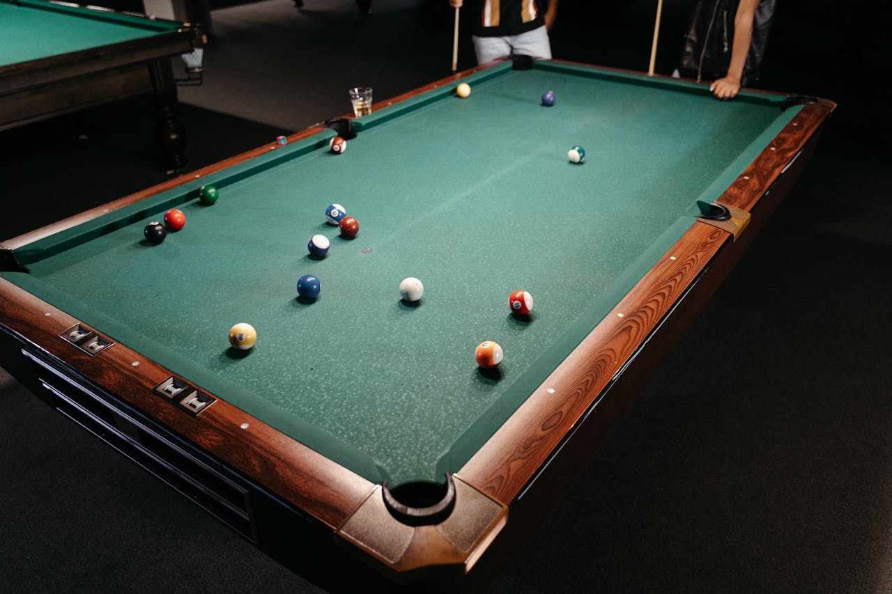 People next to the pool table
