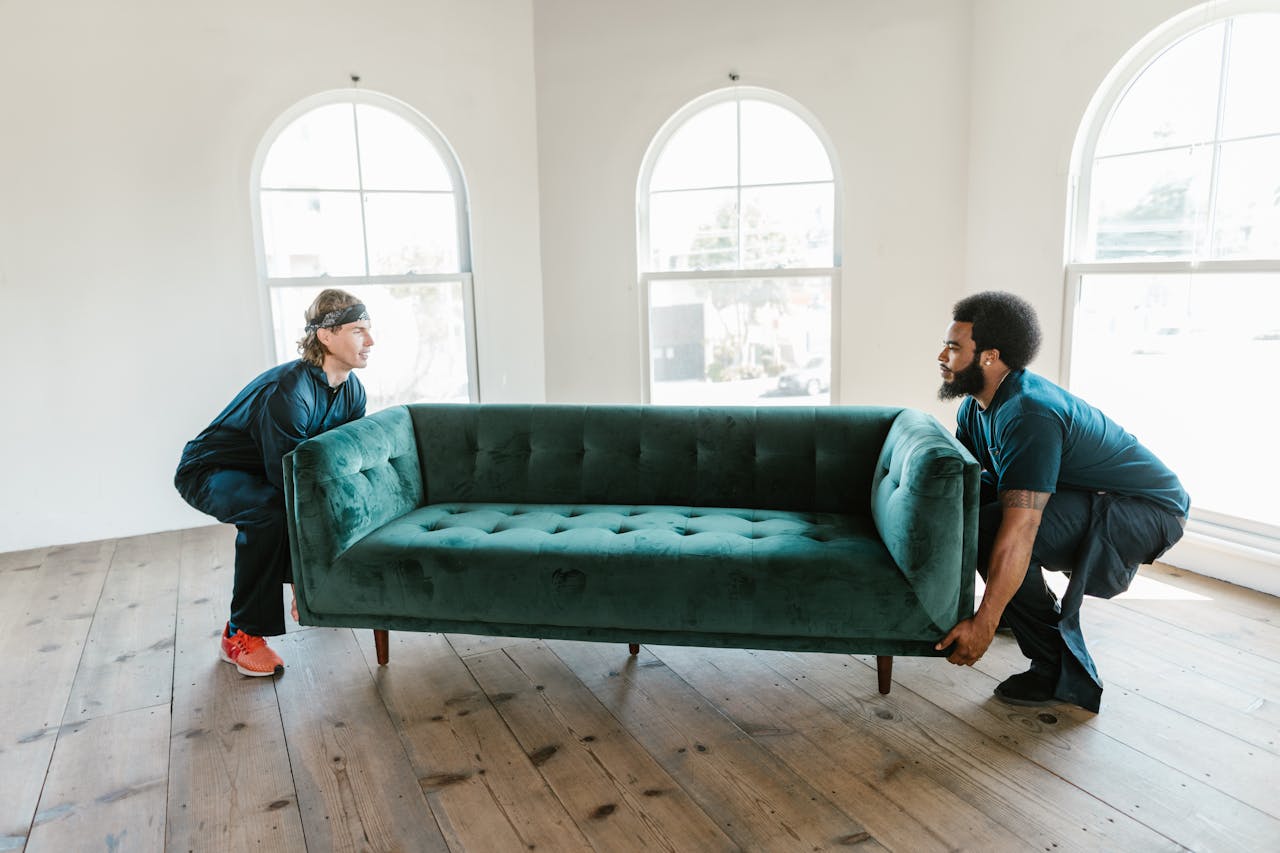 Two movers carrying sofa