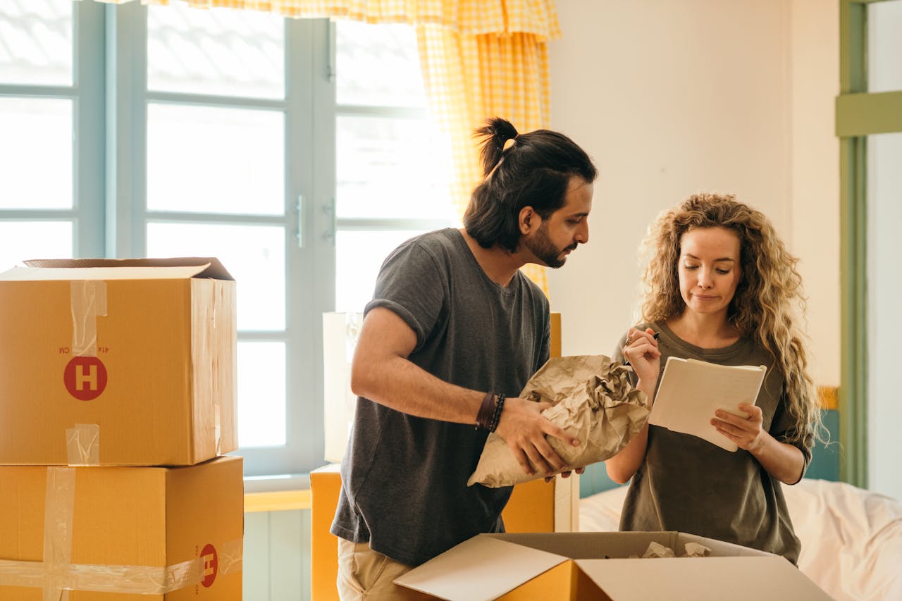 A couple writing down what factors affect moving quotes in San Antonio