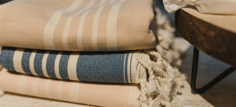 Stack of blankets placed on wooden table