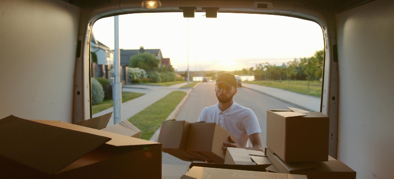 Man Putting Boxes Inside a van