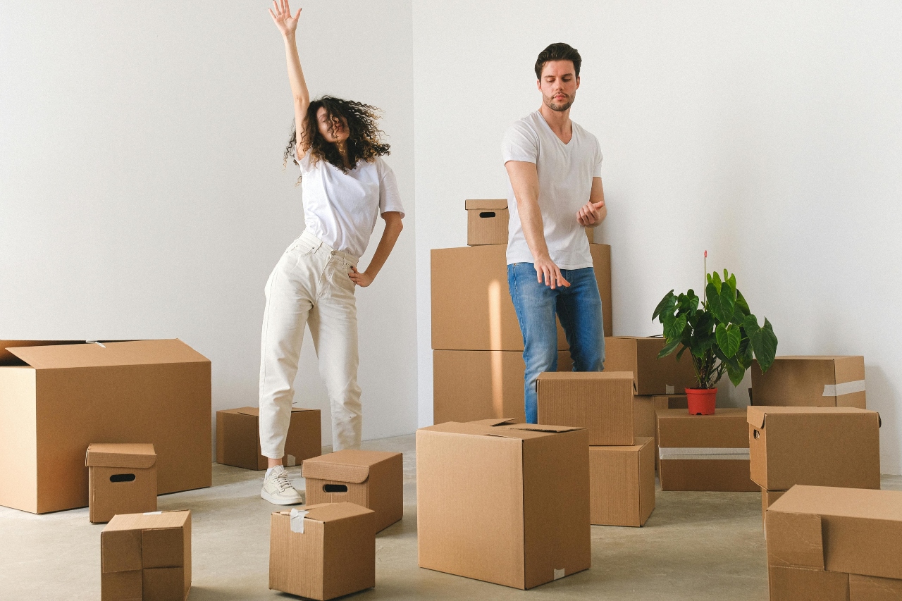 A joyful young couple dances in their new apartment while settling in after their move from Uvalde to Martinez.