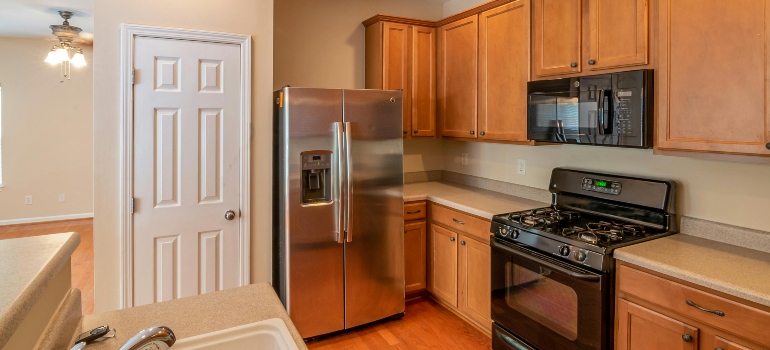 Empty kitchen prepared during move-in cleaning process before furniture arrives.