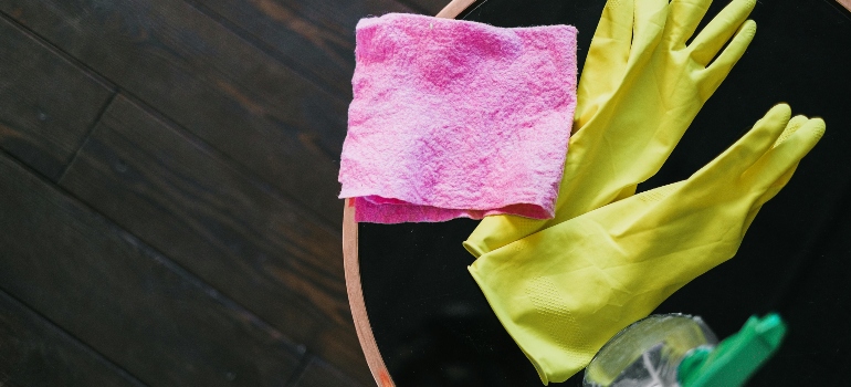Cleaning supplies with gloves and cloth.